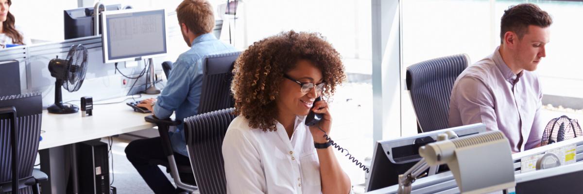 Woman making a phone call in a busy government office