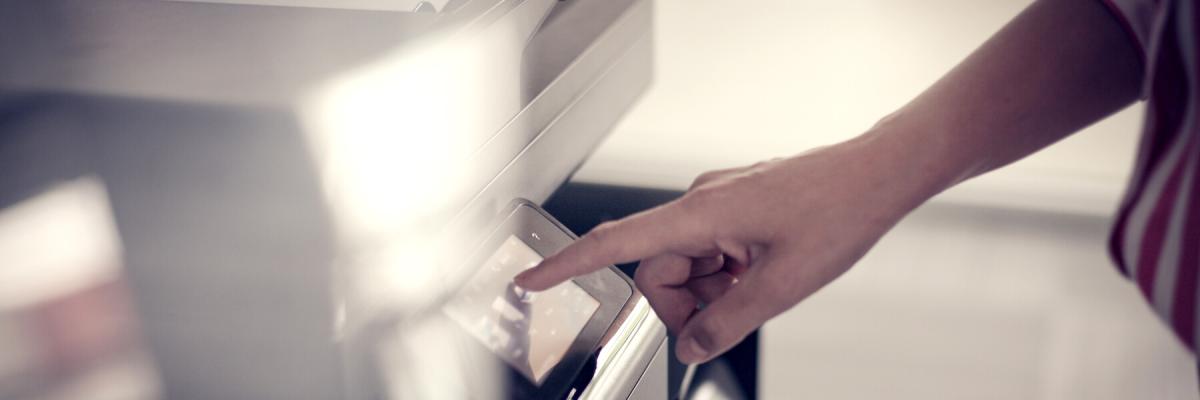 Business woman making a selection on a printer interface.